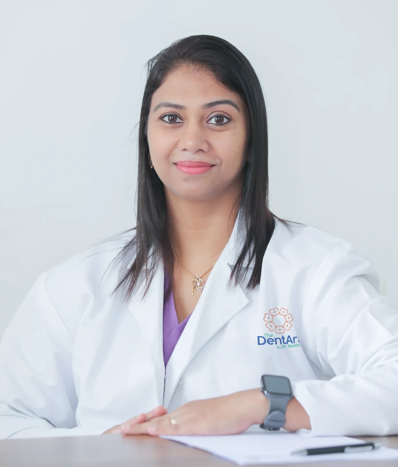 Dr Neethu John wearing a white coat at The Dentart.
