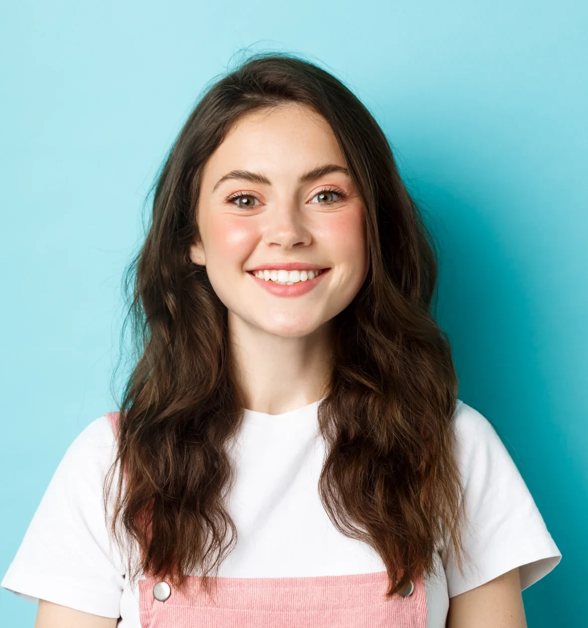 A smiling woman wearing a white T-shirt.