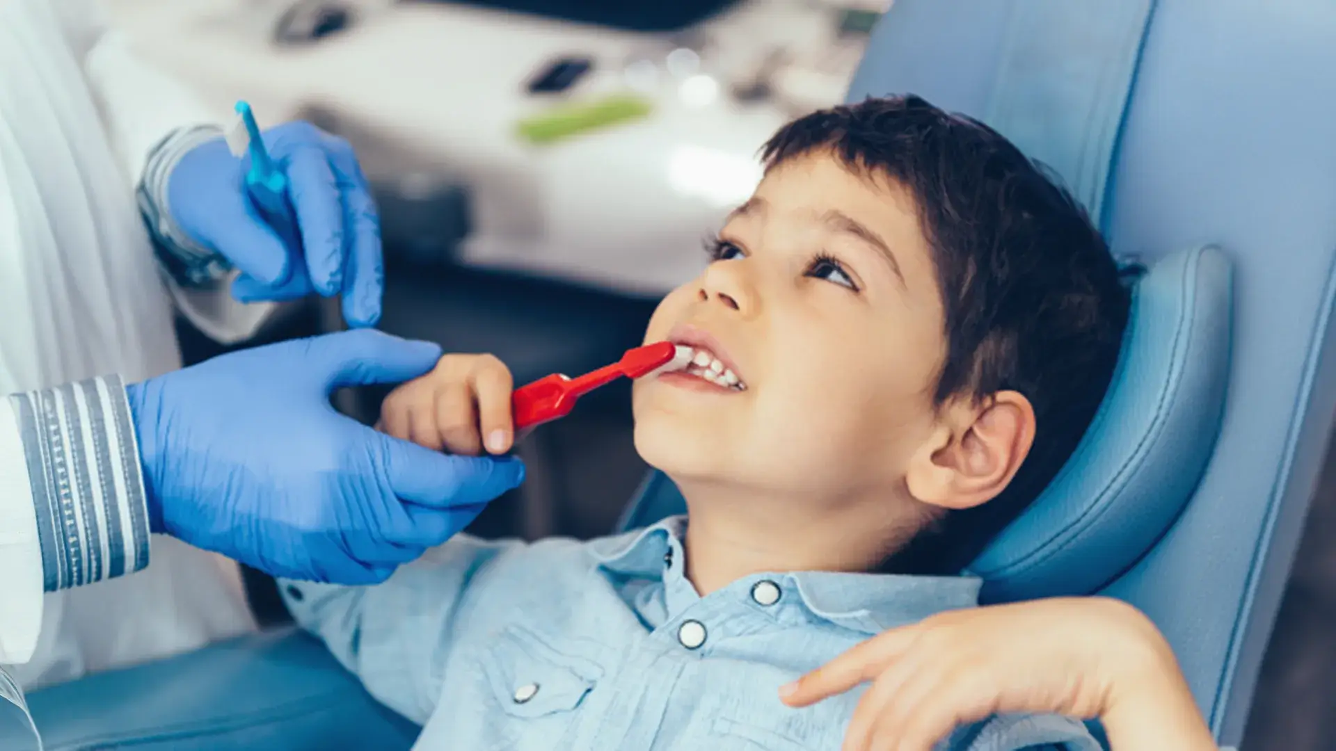 Smiling child brushing teeth at a dental check-up - The Dentart, Sarjapura, Bengaluru