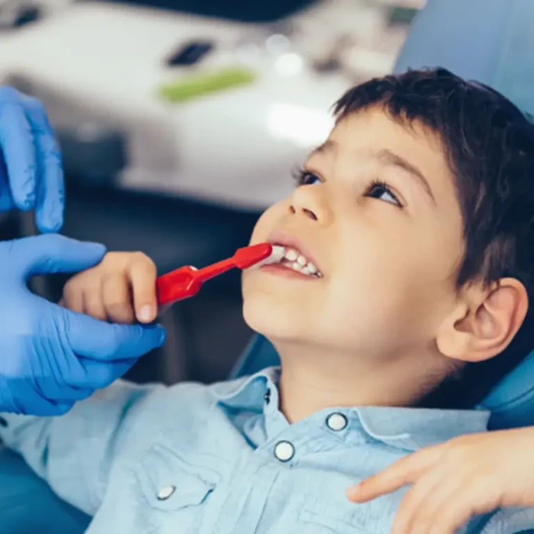 Smiling child brushing teeth at a dental check-up - The Dentart, Sarjapura, Bengaluru